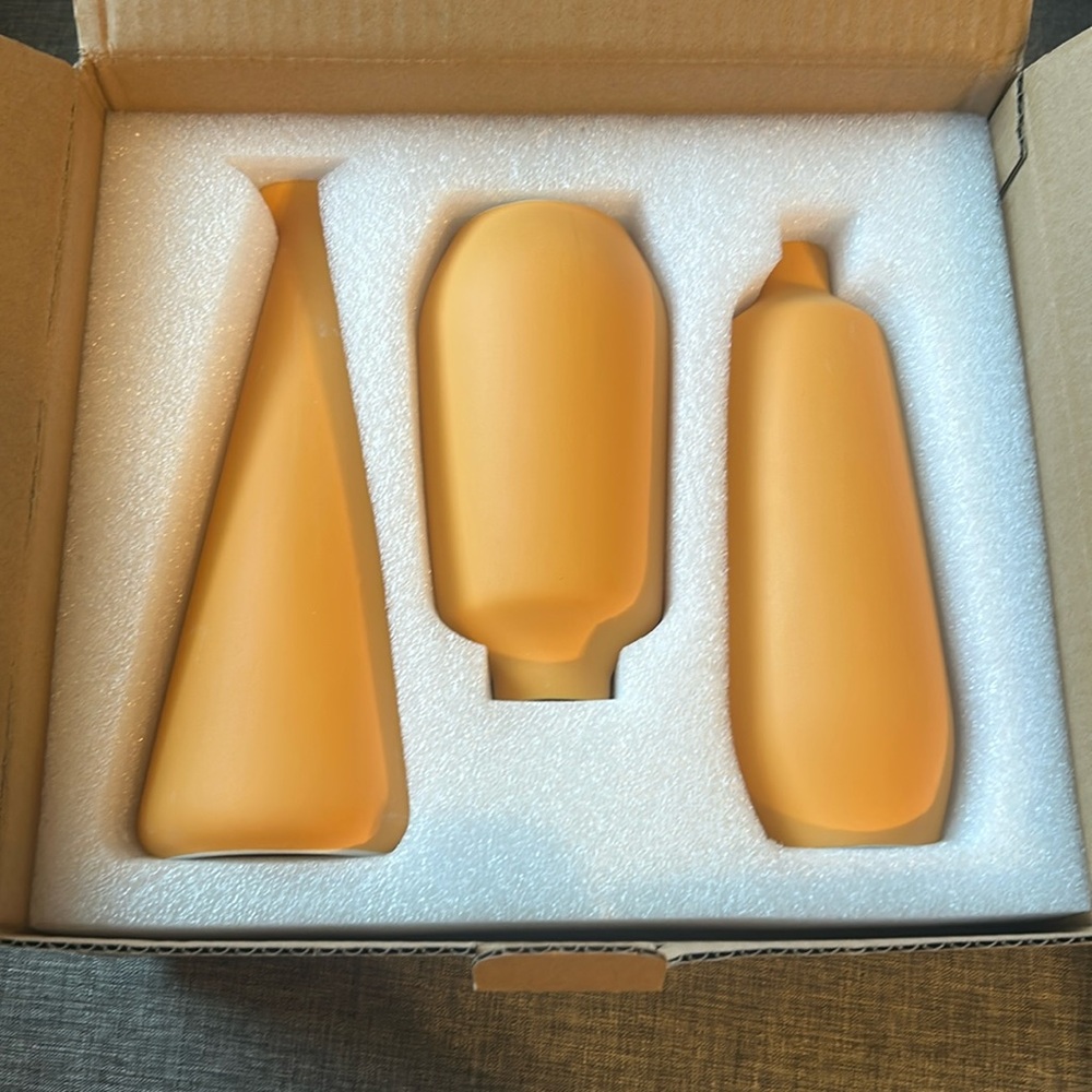 Brand new set of vases in orange color. Three individual vases, all different.
